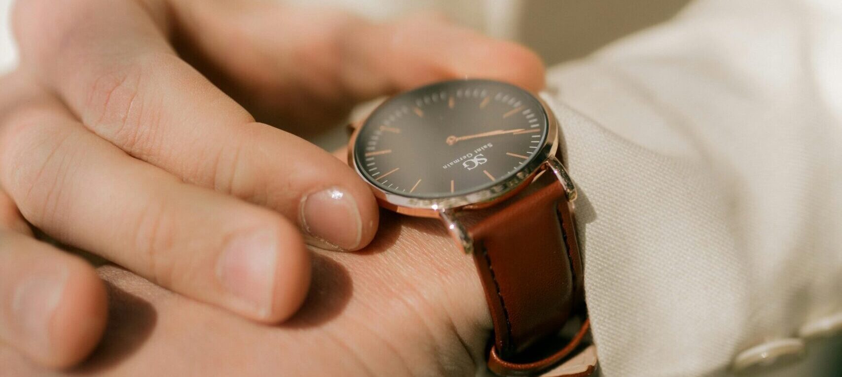 A close-up shot of an elegant wristwatch on a person's wrist, styled in a sophisticated manner.